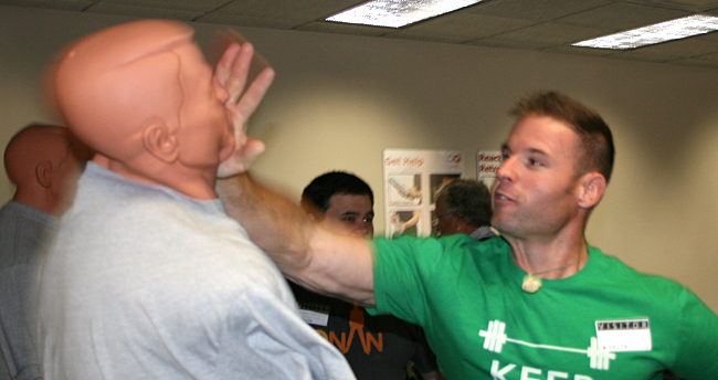 One member of the training class attacks a mannequin in a manner designed to disable an aggressive passenger. Photograph ©2013 by Brian Cohen.