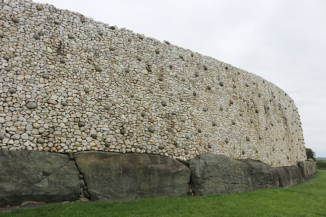 The white quartz stones and round dark granite rocks on the outer wall along the front of the passage tomb were added later and were not part of the original construction. Photograph ©2014 by Brian Cohen.