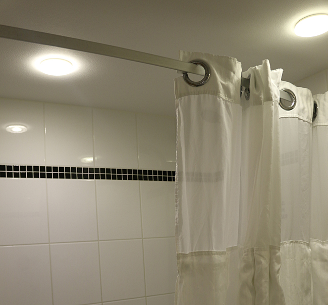 There was a curtain on a shower rod curved outward — no mess when showering! Photograph ©2014 by Brian Cohen.