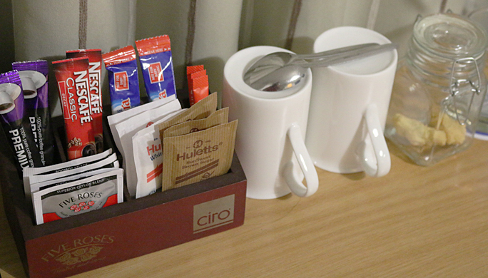 The coffee area of the desk with its complimentary offerings. Photograph ©2015 by Brian Cohen.