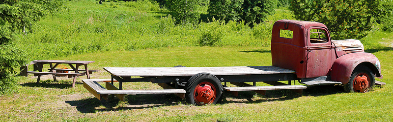 a wooden table with a red wheel on it