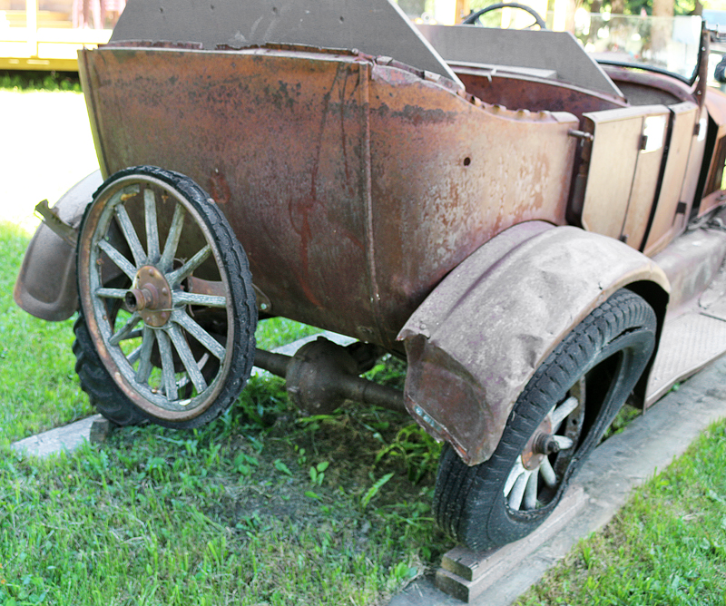 an old rusty car on grass