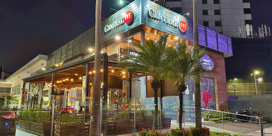 a building with palm trees and a sidewalk