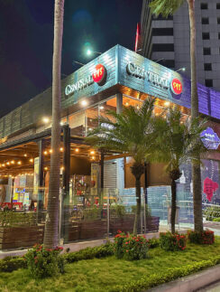 a building with palm trees and a sidewalk