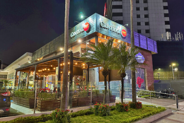 a building with palm trees and a sidewalk