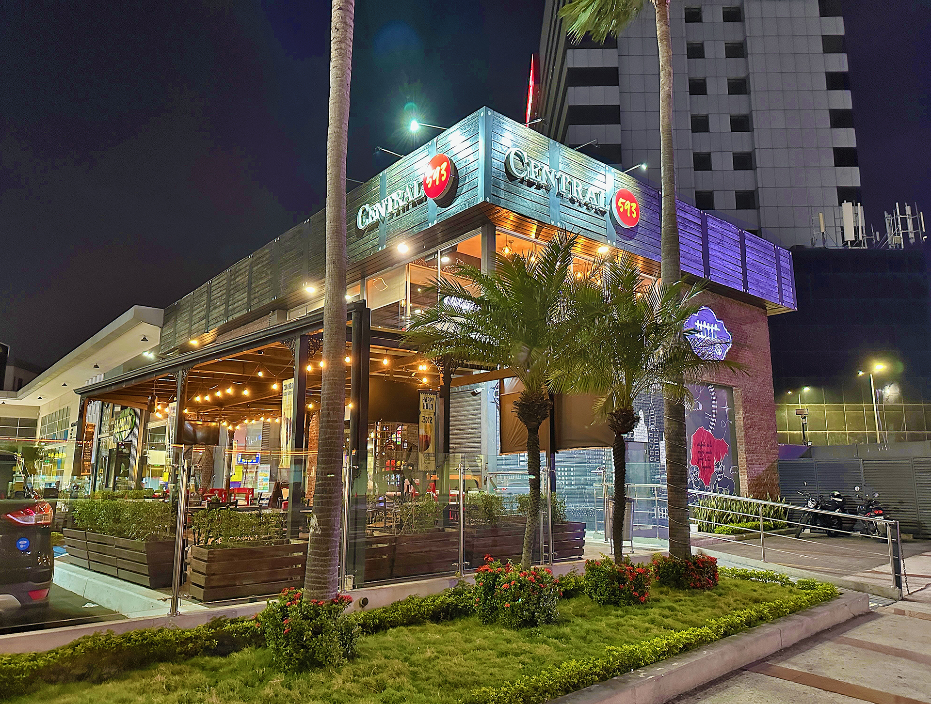 a building with palm trees and a sidewalk