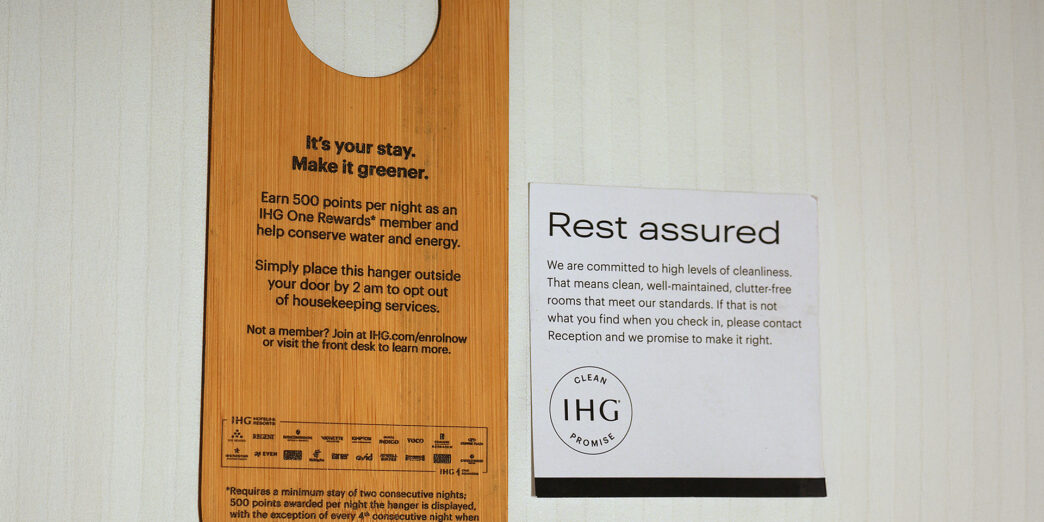 a wooden door swinger with a sign next to it