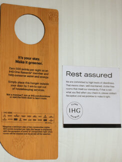 a wooden door swinger with a sign next to it