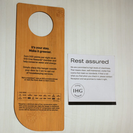 a wooden door swinger with a sign next to it