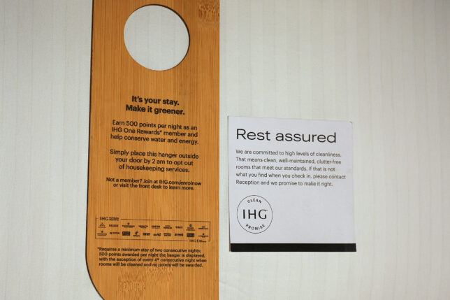 a wooden door swinger with a sign next to it