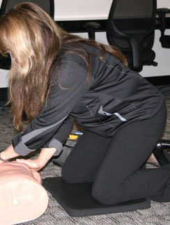a woman kneeling on a mannequin