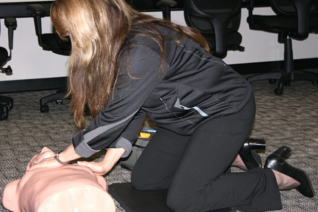 a woman kneeling on a mannequin