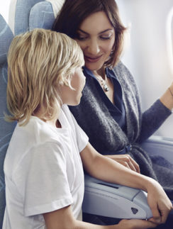 a woman and a child sitting on an airplane
