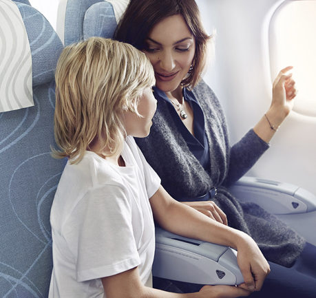 a woman and a child sitting on an airplane