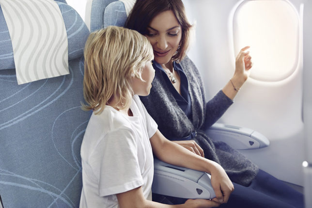 a woman and a child sitting on an airplane