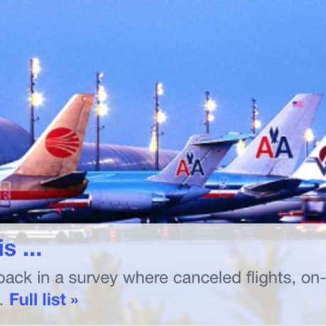 a group of airplanes parked at an airport