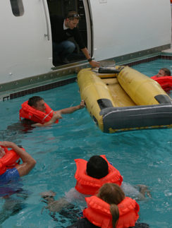 a group of people in a pool with life jackets