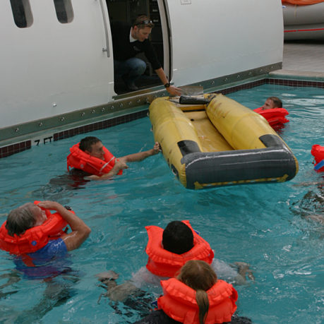 a group of people in a pool with life jackets
