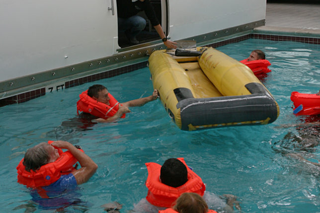 a group of people in a pool with life jackets