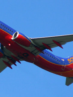 a red and blue airplane in the sky
