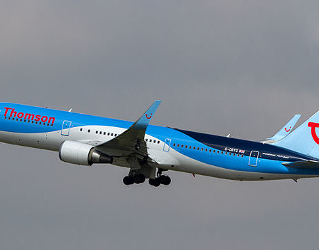 a blue and white airplane in the sky