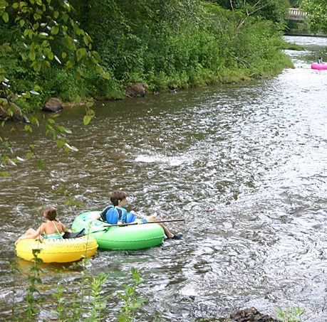 a group of people in tubing on a river