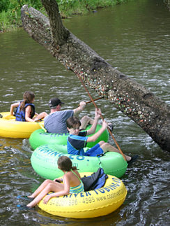 a group of people on tubing in a river