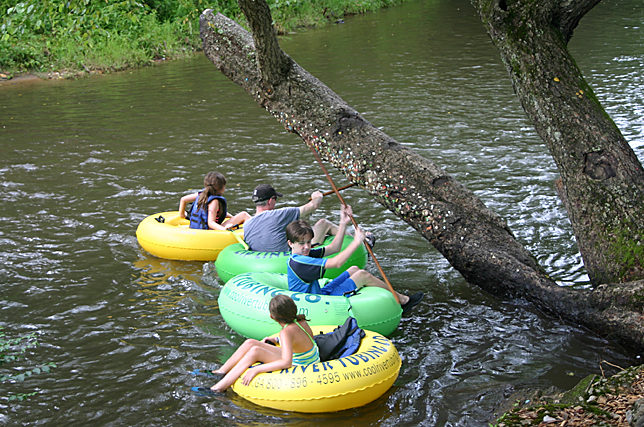 a group of people on tubing in a river