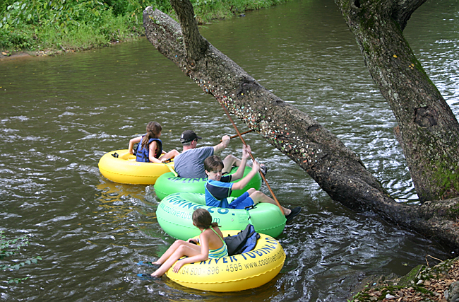 a group of people on tubing in a river