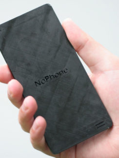 a hand holding a rectangular black device