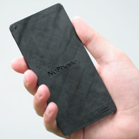 a hand holding a rectangular black device