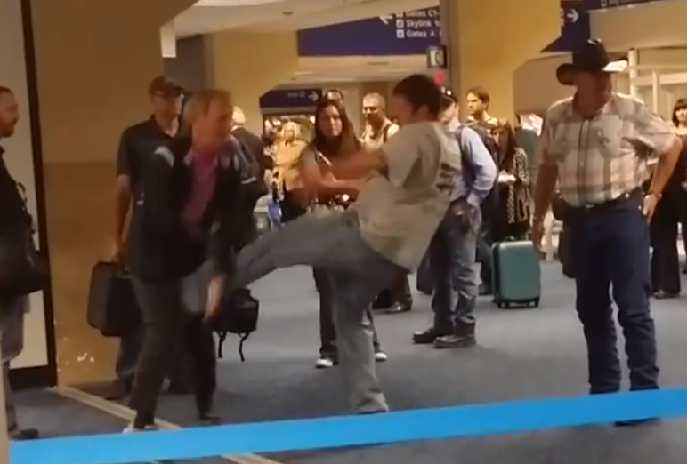 a man kicking a man in a line