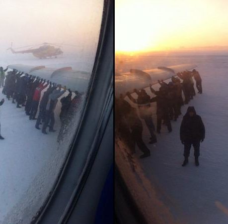 a group of people holding up a plane