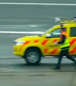 a person walking next to a yellow car