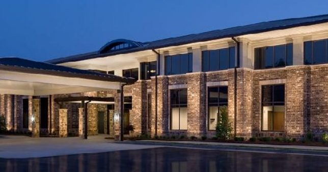 a building with a pool in front of it