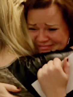 a woman hugging another woman