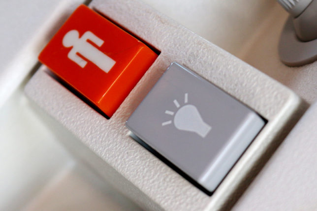 Orange flight attendant call button