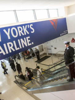 a group of people walking up an escalator