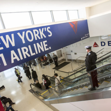 a group of people walking up an escalator