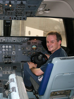a man sitting in a cockpit of an airplane