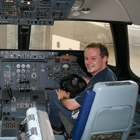 a man sitting in a cockpit of an airplane
