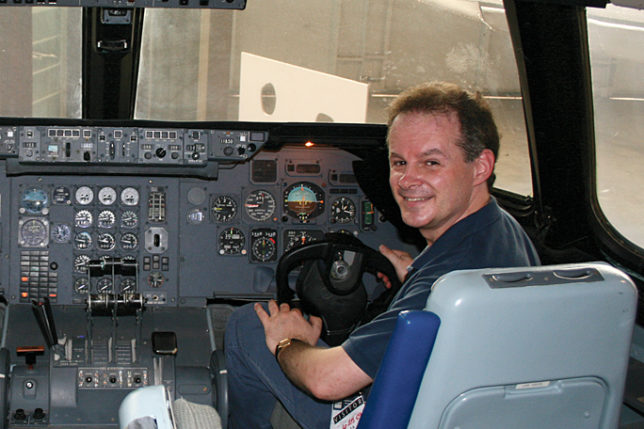 a man sitting in a cockpit of an airplane
