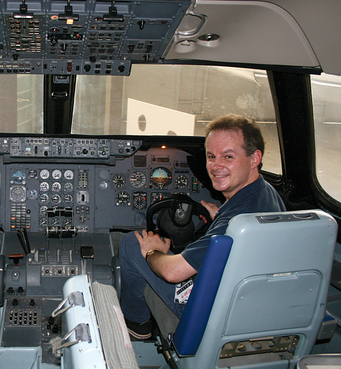 a man sitting in a cockpit of an airplane