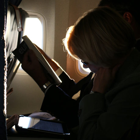 Silhouette passenger economy class cabin sun