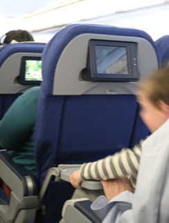 Unruly child aboard airplane boy