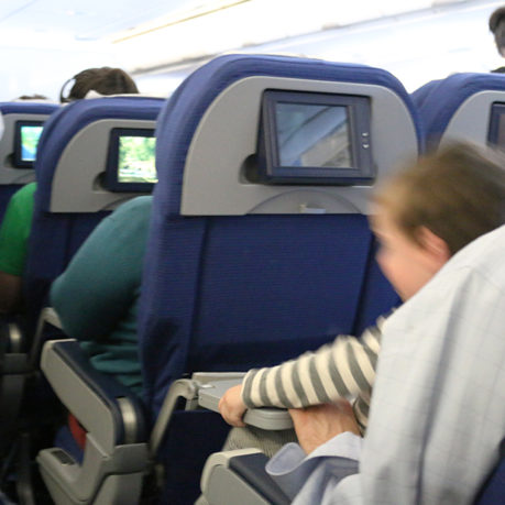 Unruly child aboard airplane boy