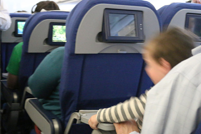 Unruly child aboard airplane boy