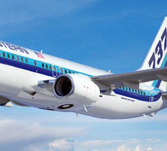 a white and blue airplane in the sky