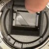 a finger on a camera lens
