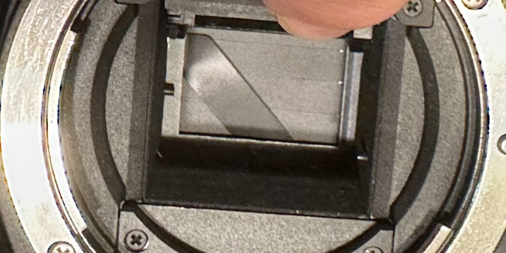 a finger on a camera lens